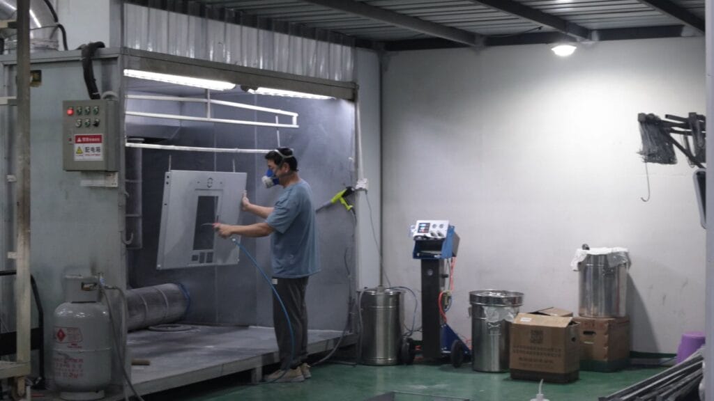 powder coating spray booth worker spraying alternate.jpg