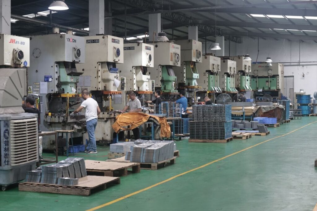 stamping press factory workers metal parts pallets